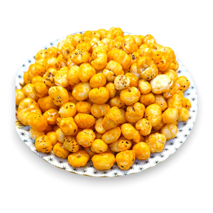 Overhead view of golden cheese and herbs coated makhana on a plate