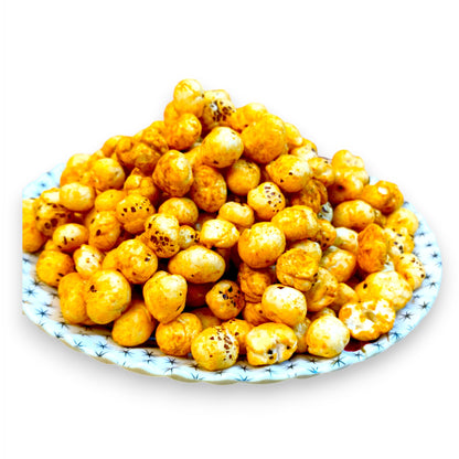Magic masala roasted makhana fox nuts piled on a patterned ceramic plate