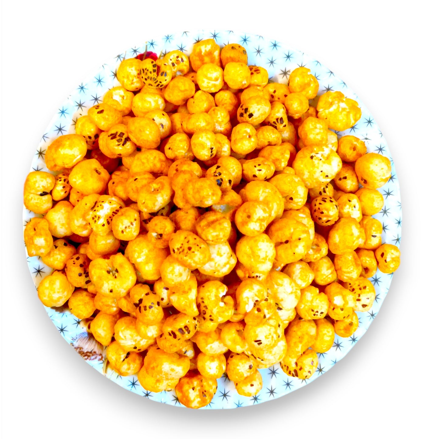 Overhead view of tangy tomato seasoned makhana filling a decorative plate