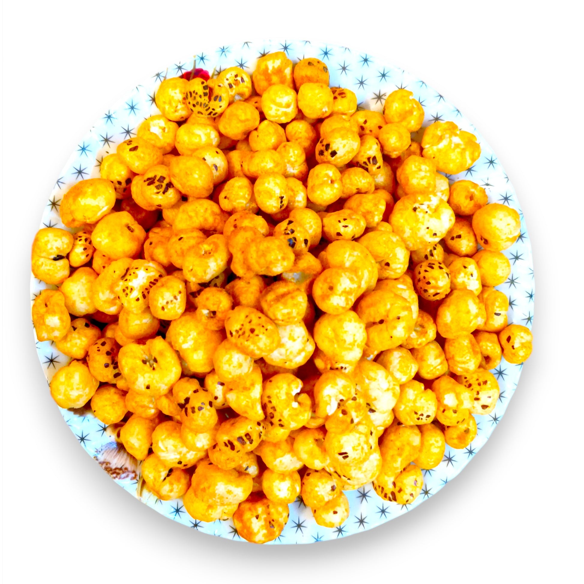 Overhead view of tangy tomato seasoned makhana filling a decorative plate